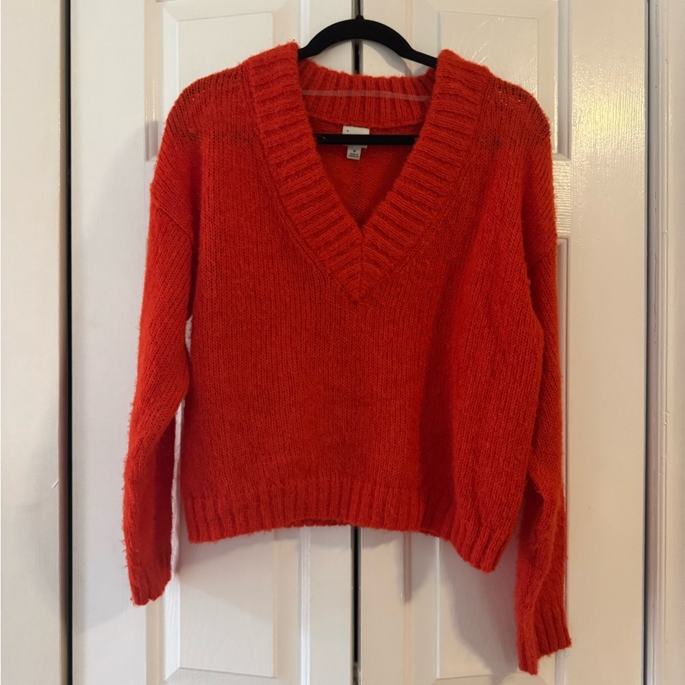 A New Day red sweater